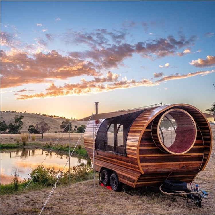 Wooden recreational wagon beside a pond at sunset